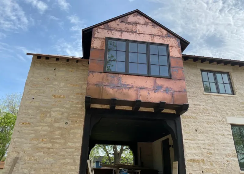 Copper metal panel facade on a stone building for Skylight Installation in Rockford