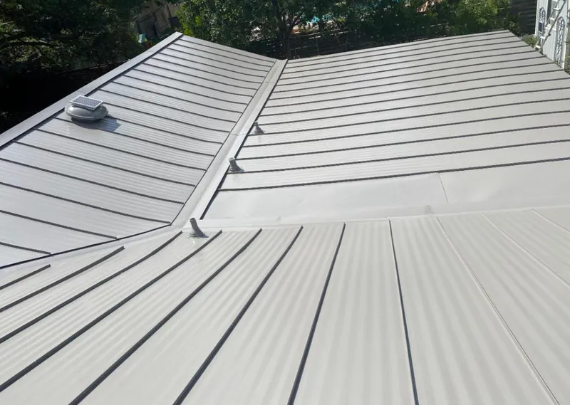 Solar attic fan installed on a metal roof for Roof Ventilation in Rockford
