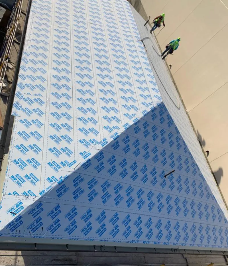 Professional roofers installing underlayment on a metal roof in Rockford